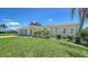 Charming single-story home with mature landscaping and neutral color scheme, with space for two cars at 4409 Eleuthera Ct, Sarasota, FL 34233