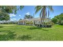 Beautiful single-story home with a well-manicured lawn and artistic plants along the facade at 4409 Eleuthera Ct, Sarasota, FL 34233