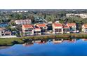 Waterfront condo featuring impact windows, tile roof, and serene water views from multiple stories at 4557 Bay Club Dr, Bradenton, FL 34210
