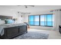Bright main bedroom with a king-size bed, ceiling fan, and a large window with ocean views at 4557 Bay Club Dr, Bradenton, FL 34210