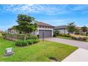 Exterior view showcasing a house with a gray garage door and well-manicured lawn at 4727 Motta Ct, Bradenton, FL 34211