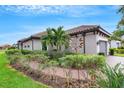 Exterior of house with gray garage door, walkway, and lush landscaping at 4727 Motta Ct, Bradenton, FL 34211