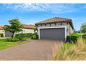 House exterior showcasing a gray garage door and a nicely landscaped front yard at 4727 Motta Ct, Bradenton, FL 34211