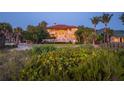 House with lights on at dusk, beach access at 507 Casey Key Rd, Nokomis, FL 34275