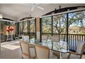 Bright dining area with glass table and lake view at 5248 Bouchard Cir # 201, Sarasota, FL 34238