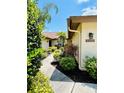 Landscaped side yard with a walkway leading to the back of the house at 7107 Heron Ct, Sarasota, FL 34243