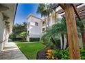 Landscaped grounds, lush foliage, and a walkway between condo buildings at 800 San Lino Cir # 814, Venice, FL 34292