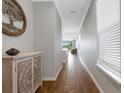 Long hallway with wood-look tile floors and access to other rooms at 8290 Velda Trl, Sarasota, FL 34241