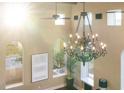 Ornate chandelier hanging from the high ceiling in a bright living room at 8855 Midnight Pass Rd, Sarasota, FL 34242