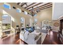 Spacious living room with high ceilings, wood beams, and ample natural light at 8855 Midnight Pass Rd, Sarasota, FL 34242