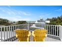 Rooftop deck overlooking the ocean with two yellow adirondack chairs at 116 50Th St, Holmes Beach, FL 34217