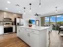 Open concept kitchen features island and stainless steel appliances at 1709 N Tamiami Trl # A421, Sarasota, FL 34234