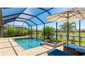 Beautiful screened-in pool and spa with a view of the water, perfect for outdoor living at 20717 Benissimo Dr, Venice, FL 34293