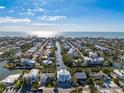 Stunning aerial view of a waterfront home with canal access and breathtaking ocean views in a desirable community at 329 Tarpon St, Anna Maria, FL 34216