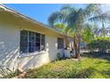 Side view of the house showcasing its brick exterior at 3826 Rilma Ave, Sarasota, FL 34234