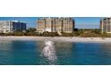 Oceanfront building, white sand beach, blue water at 435 L Ambiance Dr # M408, Longboat Key, FL 34228
