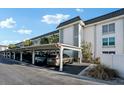 Condo building with covered parking and landscaped grounds at 4430 Exeter Dr # M108, Longboat Key, FL 34228