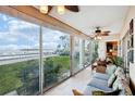 Sunroom with water views and comfortable seating at 4430 Exeter Dr # M108, Longboat Key, FL 34228