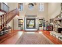 Spacious living room with hardwood floors, high ceilings, and a stone fireplace at 4938 Hubner Cir, Sarasota, FL 34241