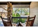 Relaxing porch with rocking chairs overlooking a scenic waterfront view at 4938 Hubner Cir, Sarasota, FL 34241