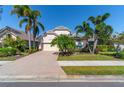 Stunning home showcasing a paver driveway and mature landscaping at 7223 Orchid Island Pl, Bradenton, FL 34202