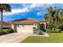 Inviting single-story home with tile roof, attached two-car garage, and landscaped yard at 750 Foggy Morn Ln, Bradenton, FL 34212