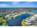 Bird's-eye view of the house and surrounding neighborhood by the water at 805 Harrington Lake N Dr # 76, Venice, FL 34293