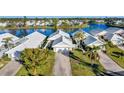 Community overview showcasing waterfront properties and lush landscaping at 805 Harrington Lake N Dr # 76, Venice, FL 34293