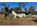 Light yellow house with green shutters, and a small yard at 1202 42Nd W St, Bradenton, FL 34205