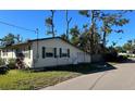 Tan house with a garage and green shutters at 1202 42Nd W St, Bradenton, FL 34205