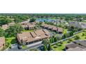 Aerial view of condo building near a lake, showcasing landscaping and neighborhood at 2347 Beneva Ter # 2251, Sarasota, FL 34232