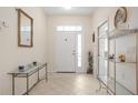 Bright and airy entryway with glass-top console table at 24181 Green Heron Dr # 84, Punta Gorda, FL 33980