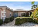 Inviting home exterior featuring a tidy walkway, manicured shrubs, and a stately double-door entrance at 322 Avenida De Paradisio, Sarasota, FL 34242