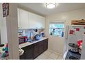 Small kitchen with white cabinets and dark countertops at 3310 Lexington St, Sarasota, FL 34231