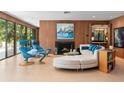 Living area with wood-paneled walls, fireplace, and plush white sectional sofa at 3348 Old Oak Dr, Sarasota, FL 34239