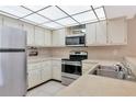Bright kitchen features stainless steel appliances and ample cabinetry at 425 30Th W Ave # C107, Bradenton, FL 34205