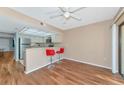 Kitchenette with breakfast bar and red stools, opens to living area at 425 30Th W Ave # C107, Bradenton, FL 34205