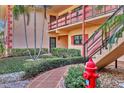 Condo building entrance with manicured landscaping and walkway at 8162 Terrace Garden N Dr # 101, St Petersburg, FL 33709