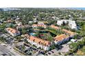 A sprawling condo community with a beautiful pond, pool, and manicured landscaping at 850 S Tamiami Trl # 227, Sarasota, FL 34236