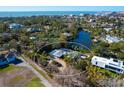 Aerial view showcasing a single story home nestled in lush landscape at 1221 S Basin Ln, Sarasota, FL 34242