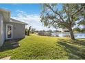 Beautiful backyard featuring lush green grass and a serene water view at 12343 Lavender Loop, Bradenton, FL 34212