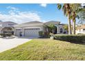 Charming home with a well-manicured lawn, a three-car garage, and attractive landscaping at 12343 Lavender Loop, Bradenton, FL 34212