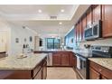 Modern kitchen featuring granite countertops and stainless steel appliances at 17118 Vardon Ter # 305, Bradenton, FL 34211