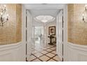 Elegant entryway with marble floors and detailed millwork at 35 Watergate Dr # 801, Sarasota, FL 34236