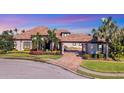 Stunning curb appeal: two-story home with a tile roof and landscaped yard at 504 Mast Dr, Bradenton, FL 34208