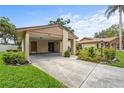 Single-story home featuring a covered carport, well-maintained lawn, and tasteful landscaping at 5111 26Th St. Ct, W # 53, Bradenton, FL 34207