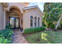 Elegant entryway with a double door and decorative columns at 7443 Riviera Cv, Lakewood Ranch, FL 34202