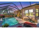 Inviting pool area with a screened enclosure and patio furniture at 7443 Riviera Cv, Lakewood Ranch, FL 34202
