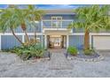 House exterior with walkway and tropical landscaping at 77 Sandy Hook N Rd, Sarasota, FL 34242