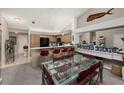 Kitchen with breakfast bar, wood cabinets, and black appliances at 9443 Burnam Dr, Weeki Wachee, FL 34613